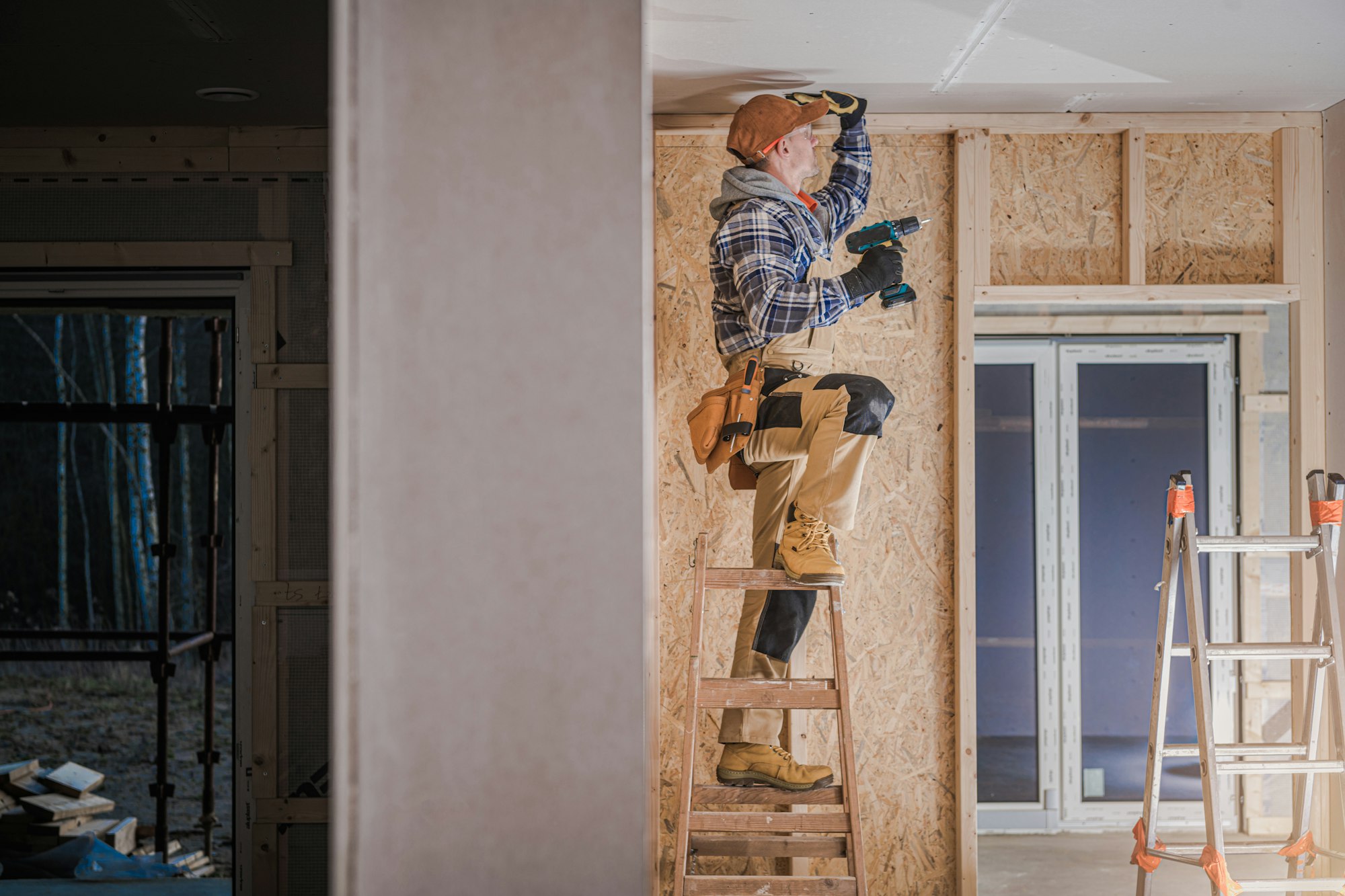 Construction Worker Installing Drywall Ceiling Elements