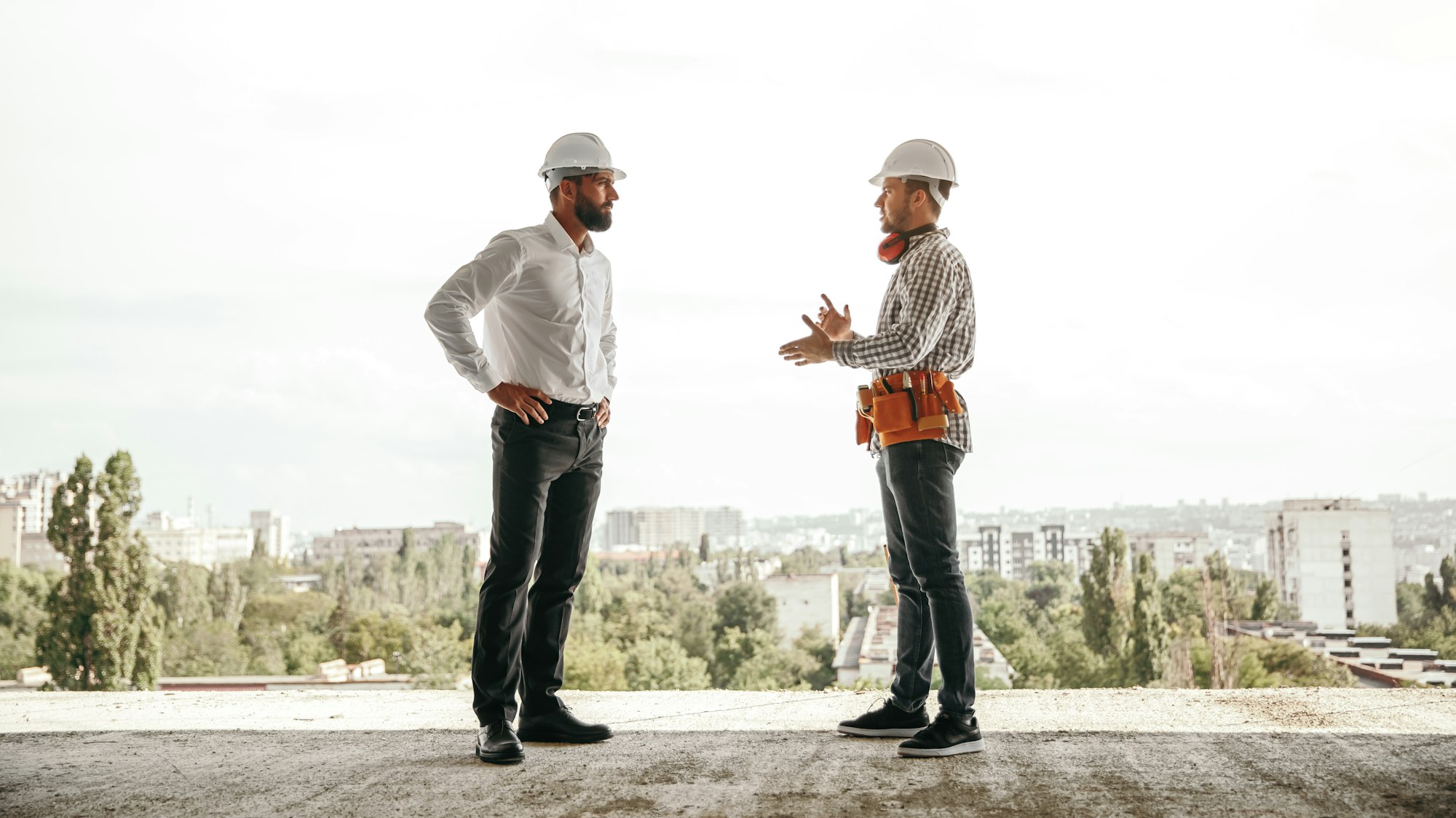 Foreman and engineer discussing project on construction site